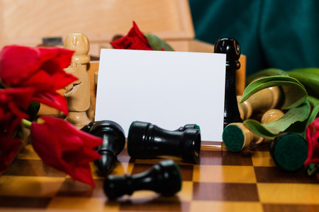 Bouquet of red tulips and chess with tag on chess boardの写真素材
