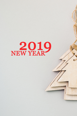Christmas and New Year's Day festive decoration, wooden Christmas tree on gray background.  Copy space for text. Flat lay. View from above with text 2019 New Year.の写真素材