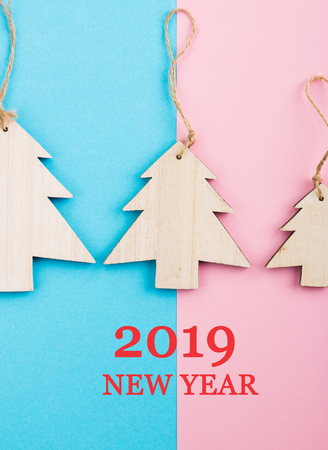 Christmas and New Year's Day festive decoration, wooden Christmas tree on blue and pink background. ...