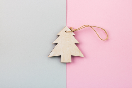 Christmas and New Year's Day festive decoration, wooden Christmas tree on pink and gray background.  Copy space for text. Flat lay. View from above.の写真素材