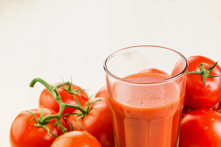 Glass of tomato juice with tomatoes on wooden background, Healthy lifestyle concept. Copy space for text.の写真素材