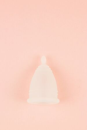 Close up of menstrual cup on pink background with copy space for text. Zero waste alternative and environmentally friendly feminine hygiene product, Top view.の写真素材