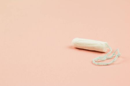 Menstruation cotton tampon on pink background with copy space for text. Feminine hygiene product, View from above.の写真素材