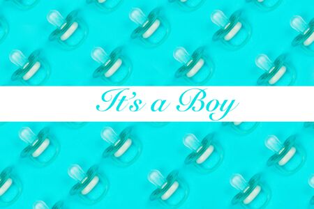 Pattern blue baby pacifiers, dummy with rubber nipple on blue background with text Its a boy. Flat...