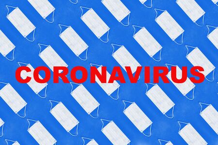 Pattern of face medical masks on dark blue background with text covid-19. Protection from coronavirus. Top view. Flat lay.の写真素材
