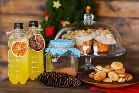 new years table with lemonade and cakes in christmas, mugs and peanuts with condensed milkの写真素材