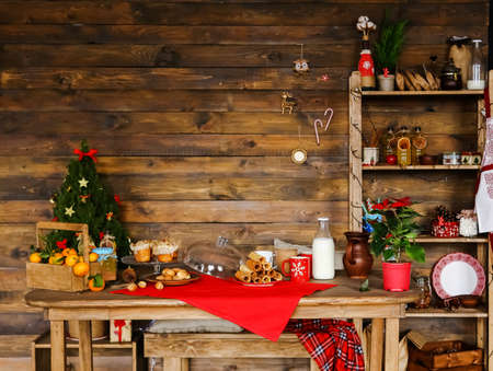 new years table with lemonade and cakes in christmas, mugs and peanuts with condensed milkの写真素材