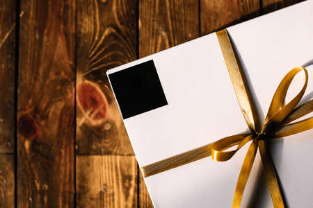 White Gift Box with Yellow Gold Ribbon Isolatedの写真素材