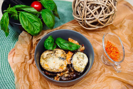 baked eggplant in cheese with spices, basil leaves and seasoned with saffronの写真素材