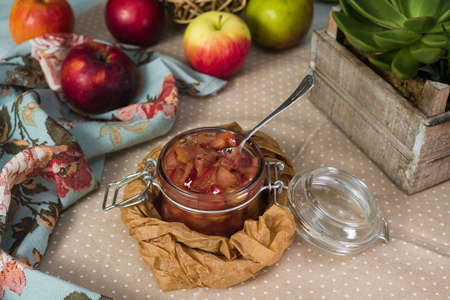 Jar of apple jam (apple jam slices). rustic style. Rustic towel and fresh apples.の写真素材