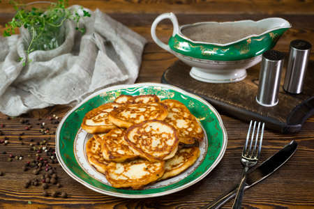 Potato pancakes with mushroom sauce. Home cooked pancakes, bunch of on a plate.の写真素材