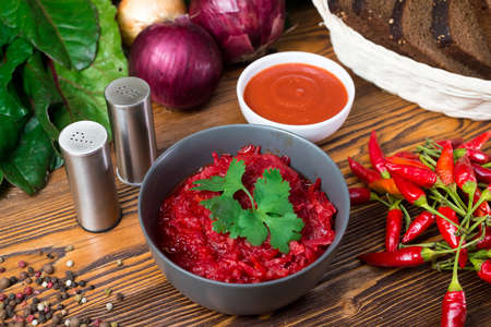 Beets stewed with carrots, onions and chili peppers. vegetable side dish. Served with tomato sauce and rye bread.の写真素材
