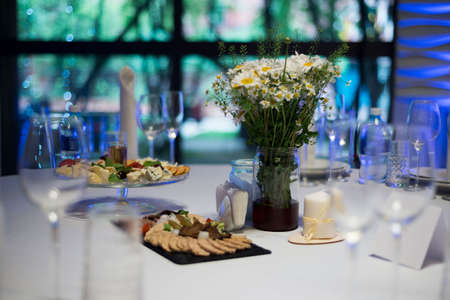 A festively served table inside the restaurant. A candle on the table. wedding banquet.の写真素材