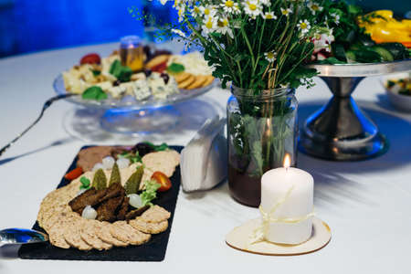 A festively served table inside the restaurant. A candle on the table. wedding banquet.の写真素材