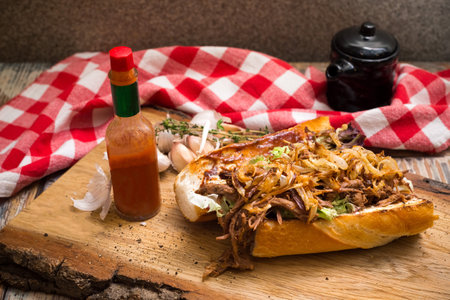 New Orleans Roast Beef Debris Po Boy sandwich. Slow Cooked Roast Beef stew filling, fried onion chips and a hot sauce.の写真素材