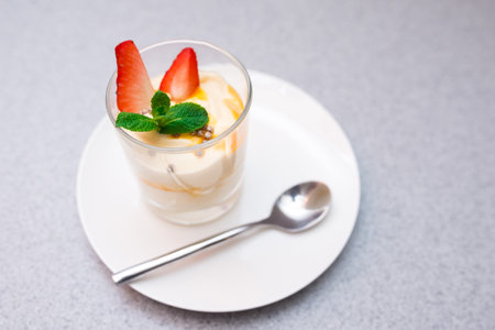 Strawberry parfait with mango sauce decorated with mint leavesの写真素材