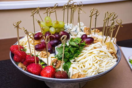 Appetizer plate: strawberry canapÃ©, Cecil cheese, blue mold cheese, grapes, walnuts, honey, mint...