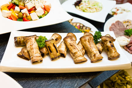 Eggplant rolls with cream cheese at the front of a buffet table. Appetizers, finger food. Georgian appetizers.の写真素材