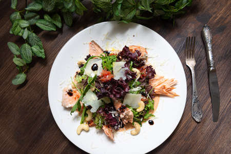portion of salad with trout (salmon, red fish meat) and grapefruit and cashews. top view.の写真素材