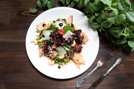 portion of salad with trout (salmon, red fish meat) and grapefruit and cashews. top view.の写真素材
