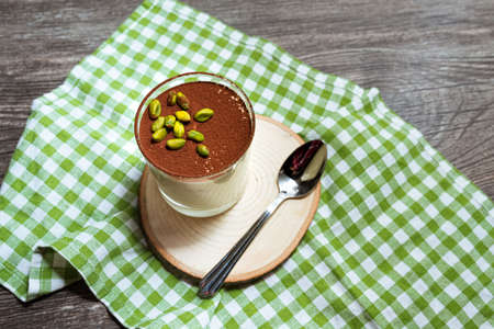 Dessert tiramisu with pistachios sprinkled with cocoa powder. View from slightly above.の写真素材