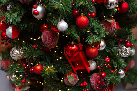 Christmas tree dressed up for Christmas and New Year's Eve. All the Christmas decorations are red.の写真素材