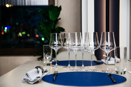 The table in the restaurant served according to the rules of etiquette. Evening lights, the interior of the restaurant.の写真素材