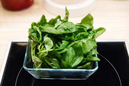 Fresh basil leaves in a glass bowl. Ingredient for the preparation of the dish.の写真素材