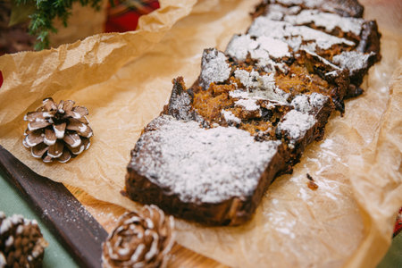 Christmas cake with dried fruit sprinkled with powdered sugarの写真素材