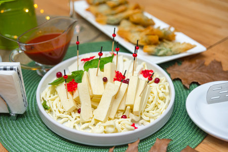 plate with a set of cheeses. cold snacks on the table.