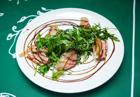 Duck fillet sous vide with fresh arugula and drunken pearの写真素材