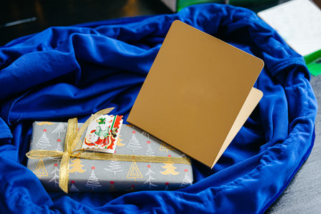 Christmas gift box on blue satin fabric background. christmas concept.