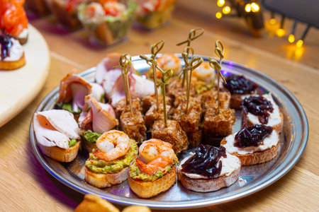 healthy appetizing plate of bruschettas for brunch with few tuna canapes on skewers with tuna shavingsの写真素材