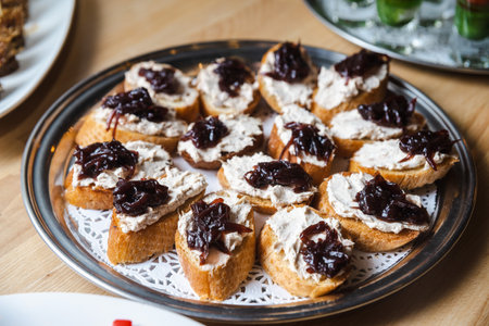 Toasts with tuna cream cheese spread and caramelized onions on a plate.の写真素材