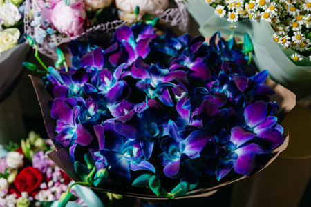 A stunning bouquet of blue and purple dyed orchids, a unique and exotic floral gift or decoration.の写真素材