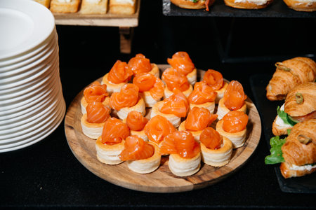 Elegant smoked salmon appetizers served on puff pastry shells, ideal for upscale events, catering, and gourmet finger food menus.の写真素材
