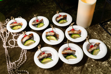 Elegant fish appetizers served in small plates with grilled zucchini slices and garnish, ideal for...