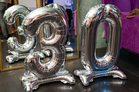 Shiny silver foil balloons shaped as number 30, used as party decoration for a 30th birthday...