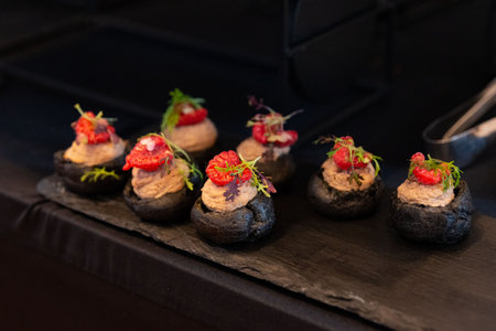 Elegant gourmet bites served on a sleek slate platter. topped with vibrant garnishes, these...