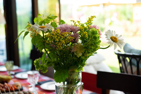 A vibrant floral arrangement featuring daisies and various summer blooms. ideal for adding a touch...