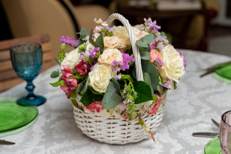 A beautifully arranged floral basket featuring roses and assorted blooms. perfect centerpiece for any celebration or event, adding a touch of elegance and color to your decor.の写真素材