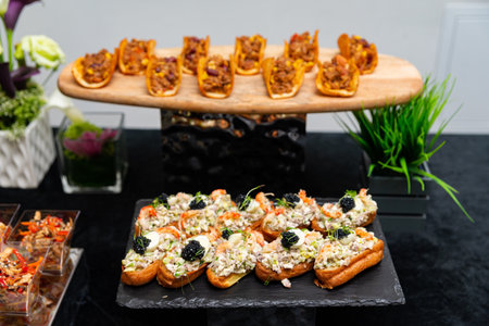 A sophisticated arrangement of hors d'oeuvres showcasing diverse culinary presentations. the scene...