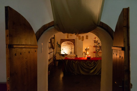 Moscow, Russia - December 11, 2025 - View through open rustic doors into an arched interior with...