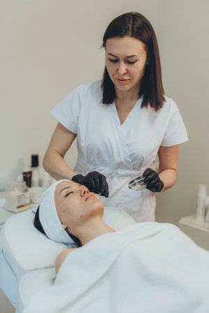 A cosmetologist-esthetician treats problem skin