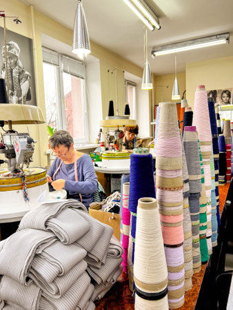 Kiew, Ukraine-December 12, 2021: At the sewing factory, seamstresses diligently work on sewing machines, crafting garments from an array of fabricsのeditorial素材