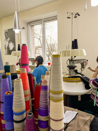 Kiew, Ukraine-December 12, 2021: At the sewing factory, seamstresses diligently work on sewing machines, crafting garments from an array of fabricsのeditorial素材