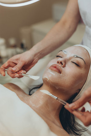 woman at the cosmetologist. She has problem skin and acne.