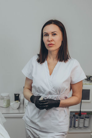 Cosmetologist esthetician performs skin treatment and rejuvenation