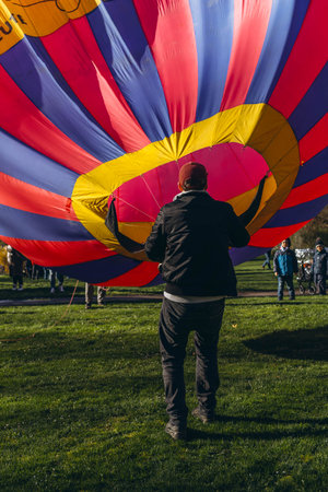 Ludwigsburg, Germany - March 23, 2024:A man inflates a balloon at a balloon festivalのeditorial素材