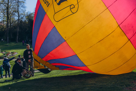 A man inflates a balloon at a balloon festival